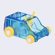 Blue plastic semi transparent box shaped car, with small wheels and 2 small brush mechanisms inside, which turns with the wheels and rotates the bristles like a sweeper.