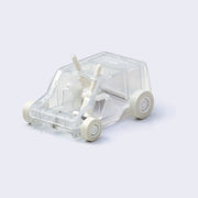 Clear plastic semi transparent box shaped car, with small wheels and 2 small brush mechanisms inside, which turns with the wheels and rotates the bristles like a sweeper.