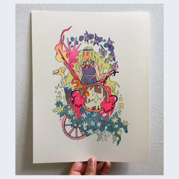 Risograph print of Norse goddess Freyja, holding a flaming sword and standing in a wooden cart with a wooden shield. Bright pink cats pull the wagon, and little gnomes forge gems nearby.