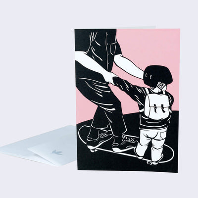 The front of a note card is shown. The notecard has an illustration of a man teaching a kid how to stand on a skateboard.