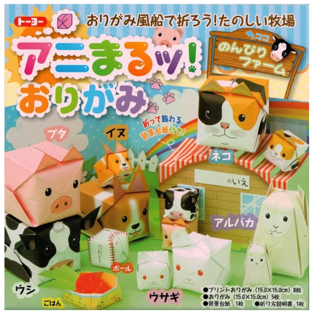 Packaging of origami set, featuring lots of box shape origami animals such as pigs, cows, dogs, cats and rabbits positioned in a paper field setting. Japanese script is all over the packaging in colorful bubble font. 