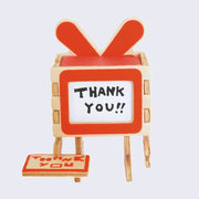 The blank side of paper card, where you may write a personal message, has been folded over the robot face. It says thank you.
