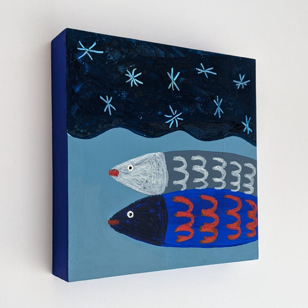 Illustration on panel of 2 simplified fish stacked atop of one another, a blue with red and a gray with white accents. They're in a body of wavy water with a simply drawn starry sky overhead. Sides of panel are painted navy blue.