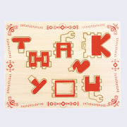 Wood card with stylized text that says thank you. A wavy red border along edges mimics morse code messaging but made to look like flowers.