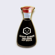 Enamel pin of a soy sauce bottle, with a red lid and small illustrated face in the middle.  "Giant Robot Fresh Brewed Soy Sauce" is written along the bottle.
