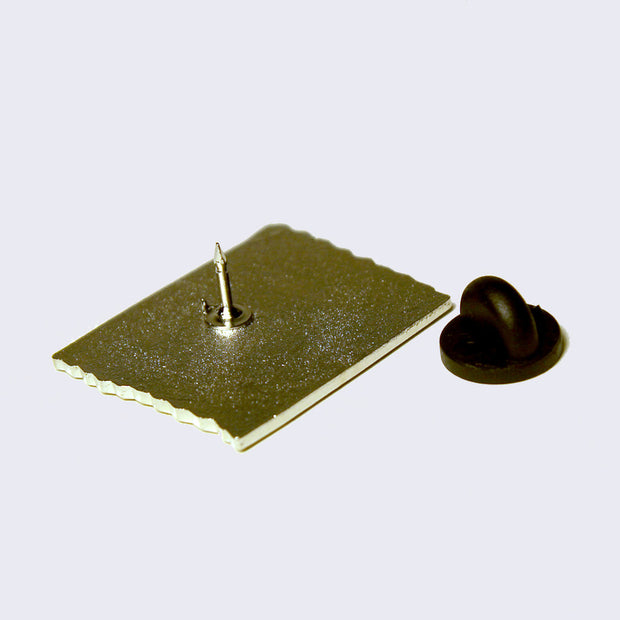 Back of enamel pin with a rubber pin backing.
