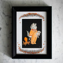 "Nap Time," described in the previous image's alt text, within a black frame on a marble counter.