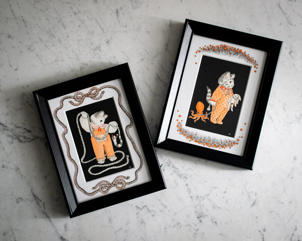 "Play Time" and "Nap Time" in their own black wooden frames, sitting side by side on a white marble countertop.