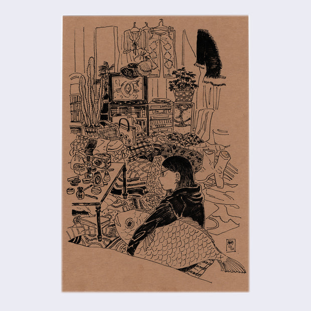 Ink drawing on tan paper of a woman in a black hoodie sitting in a very messy house space, holding a large fish under her left arm. Scattered all around are beauty products, blankets, clothes and books.