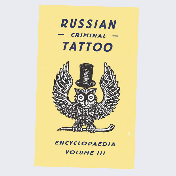 All yellow book cover with a black and white illustrated owl, pattern detail similar to etchings, with a top hat and perched on a crow bar. "Russian Criminal Tattoo" is written in bold black font.