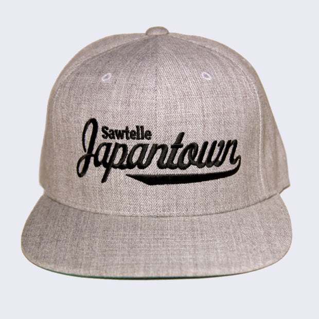 Front of heather gray cap with black embroidery. Sawtelle is stitched in a simple style, while Japantown is stitched in a larger cursive text.