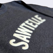 Close up displaying the word "Sawtelle" with semi-3D letter sewn onto the sweater.