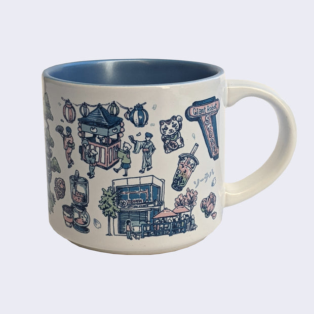 White ceramic mug with a metallic blue interior and various illustrations on it, all within a color scheme of blue, pink, white and green. Illustrations include a maneki, a boba, an exterior of a restaurant, a drip coffee machine, a store sign that says "Giant Robot Store" and a group of people walking under paper lanterns.