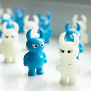 A window sill with many Big Boss Uamou figures, alternating between cyan colored and a semi translucent white (glow in the dark).