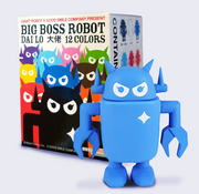 A small blue sculpted Big Boss Robot figure standing with its arms at its side. It stands in front of a single cardboard box that has illustrations of many Big Boss Robots with "Big Boss Robot" written at the top.