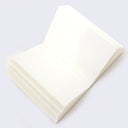 Inside of sketchbook. The blank white pages splay open.