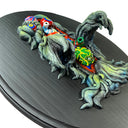 Side view of a sculpture of Hedorah mounted on wood, similar to a scientific specimen. Half of Hedorah is exposed internally, with many colorful organs of all different shapes, patterns and textures.