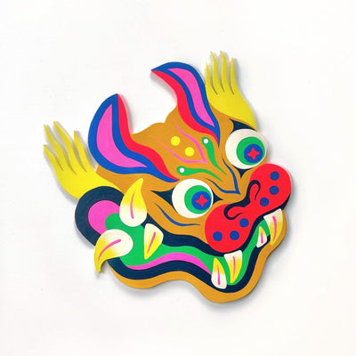 Die cut painted wooden panel of a old Asian style tiger dragon, similar to one in a parade. It is very colorfully painted and has sharp curved teeth and yellow flowing hair on the sides of its head.