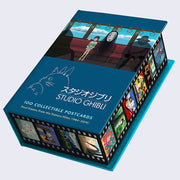 Closed box of 100 Studio Ghibli postcards, featuring an illustration from Spirited Away of Chihiro and No Face sitting in a train car. Around the box is a film strip design, with various Ghibli art in each cell.