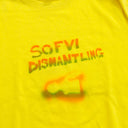 Close up of stenciled text in orange and green gradient that says so foo bee dismantling. Below is a stencil silhouette of vinyl toy upper torso.