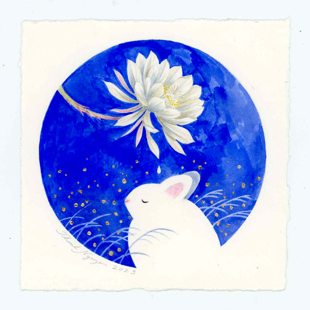 Circular watercolor drawing on a square piece of cream paper. The circle is blue with a white rabbit at the bottom, sitting with its eyes closed. Above it is a white flower, extended out from its stem with a single dew drop falling down onto the bunny's head.