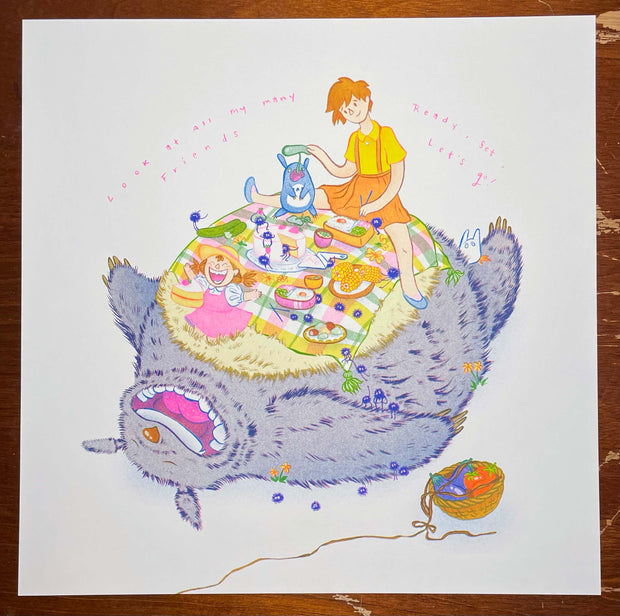 Risograph print of Totoro, laying on the ground on his back and smiling widely. Atop his fluffy stomach is a picnic set up with a wide variety of food and dust sprites accompanying Chibi Totoro and Mei and Satsuki from My Neighbor Totoro.