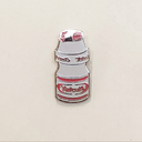 Gif of enamel pin of a small Yakult bottle packaging, white with red design accents. One image is of pin glowing in the dark and one is of pin in light.