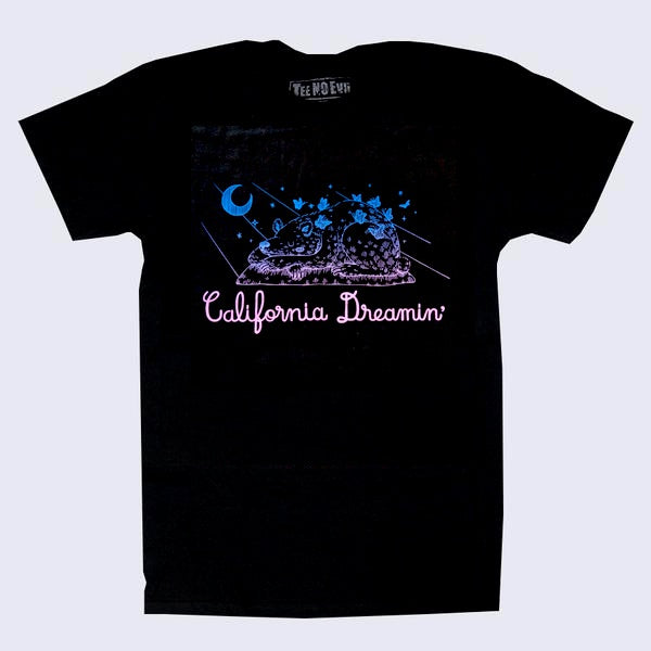 Front side of black t-shirt. Drawing of a sleeping bear under a starry sky that goes from blue to purple. Text in pink says California dreaming.