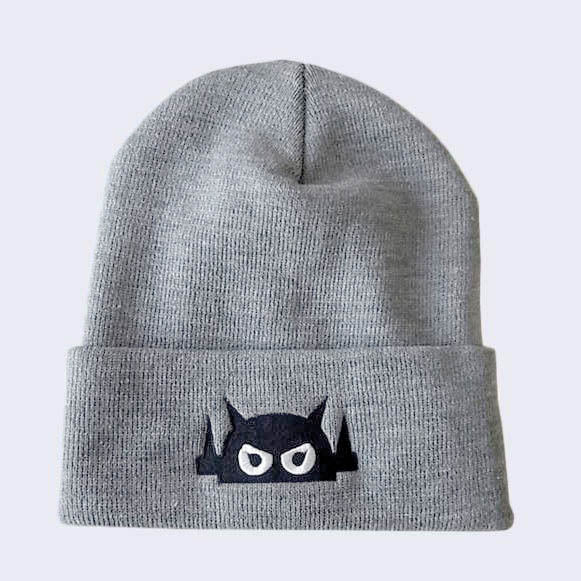 A grey knit cap with robot head stitched on cuff in black thread.