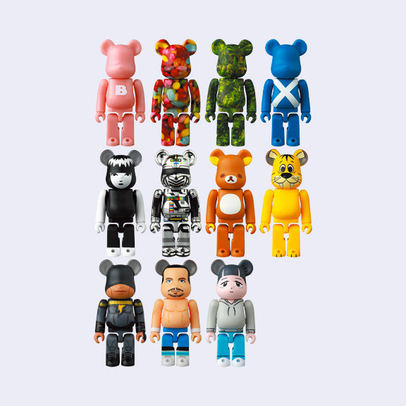 11 differently designed Bearbrick figures, designs being; pink, jellybean, rainforest, Scottish flag, Emily is Strange, Mecha, Rilakkuma, Flinstones tiger, Black Adam, and 2 artist figures.