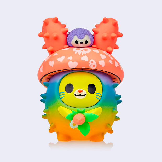 Vinyl figure of a bunny with a rainbow colored round, spiked body like a cacti. Its head is a mushroom cap with a small purple hedgehog on its head.