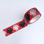 Rolled out washi tape, displaying pattern of red tape with alternating white and black Big Boss Robots.