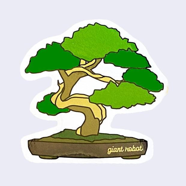 White cut out sticker with a thriving green bonsai tree, in a very shallow brown pot with "Giant Robot" written in light brown cursive on the bottom right.