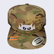 Front view of camo baseball hat. Robot head is stitched on with white thread. Its eyes are stitched in black thread but with white pupils.