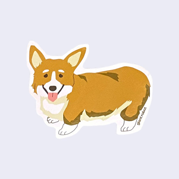 White cut out sticker with a smiling brown and white corgi, standing with its tongue out. "Giant Robot" is written in very small brown font near its back leg.