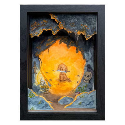 Painting of a small dog, sitting at the mouth of a cave with a dagger in its mouth. A bright orange and yellow glow comes out from the cave. Outside is a sword, candles, coins, a skull and a raven atop of it. Cut pieces of paper frame the setting of the piece within a shadow box.