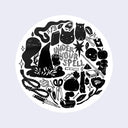 White circle sticker with drawings of objects used to cast magic spells. Stylized text in the center says under your spell.