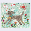 Felt 2D sculpture of a smiling dog jumping and wearing a teal collar with a gold bone hanging off the middle. A white bird sits atop its head.