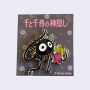 Brooch of Soot Sprite waving hello and holding a glittery gold and a glittery pink star in one arm.