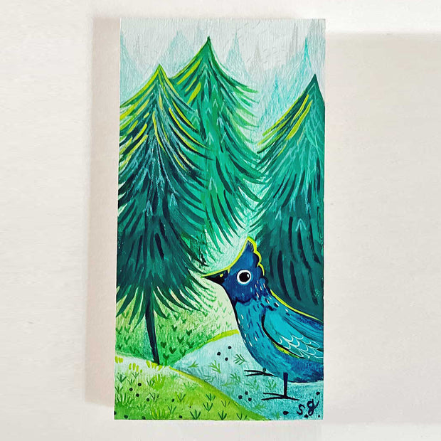 Painting of a cartoon blue bird standing on round hill hounds with large pine trees behind. Painting is primarily made of blues and greens with yellow highlights.