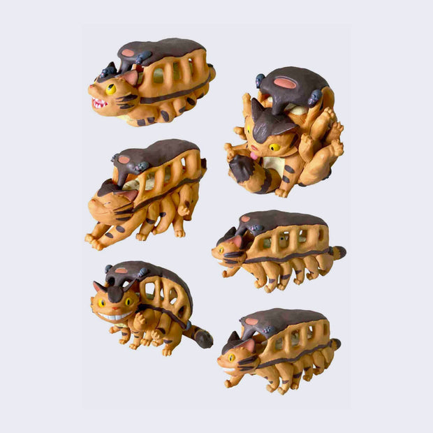 6 differently designed Catbus vinyl figures. Options include: Catbus sitting and looking up, Catbus stretching, Catbus waving, Catbus licking its tail, Catbus walking with creature inside and Catbus walking with empty bus.