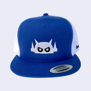 Front view of royal blue baseball cap. Robot head is stitched on with white thread. Its eyes are black but with white pupils.