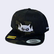 Dark camo patterned cap with a white embroidered Big Boss Robot head on the front of the cap.