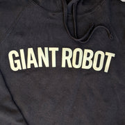 Close up of text printed across the chest area of black hooded sweatshirt.