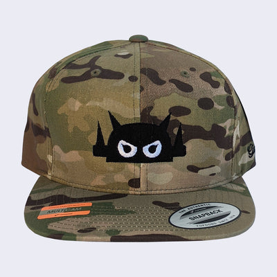 Front view of camo cap. Robot head stitched on in black thread with white eyes and black pupils.