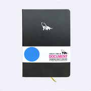 Black pleather notebook with a small embossment of a pair of long necked dinosaurs, in the upper center of journal. Paper sleeve reads "Document Drawings Drafts Dreams."