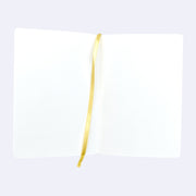 Open spread of blank sketchbook pages, with a yellow place marker ribbon running down the center.