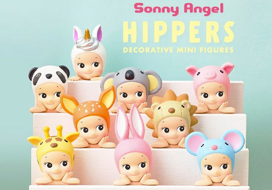 9 Kewpie baby figures smiling sweetly and looking off to the side, with their head in their hands and elbows propped flat as if on a wall. They each wear different animal hood hats, such as: unicorn, panda, koala, pig, fawn, lion, giraffe, bunny and mouse.