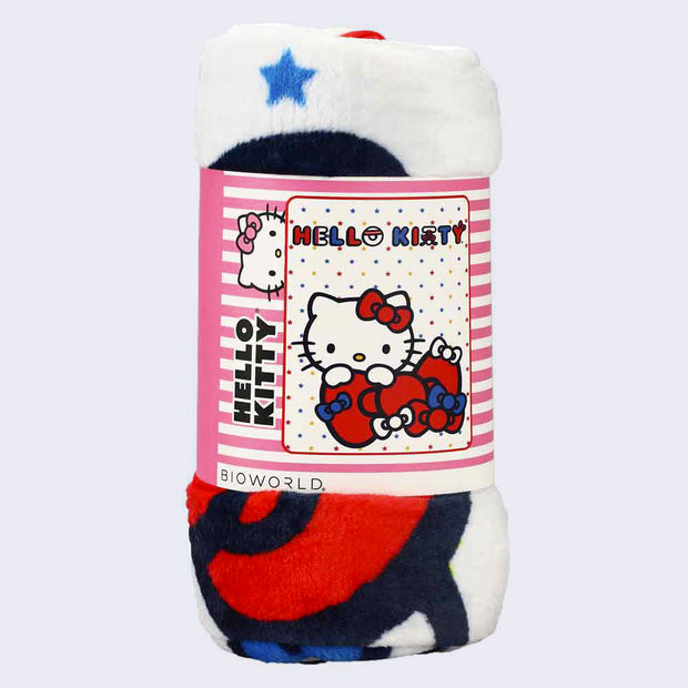 Rolled plush blanket, held in a cardboard wrapping, pink with white stripes and a photo of the spread out plush.