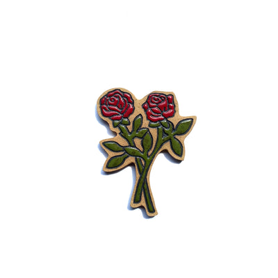 Stoneware die cut tile of a pair of two cut red roses. Their cut stems are overlapped and each have 4 leaves.